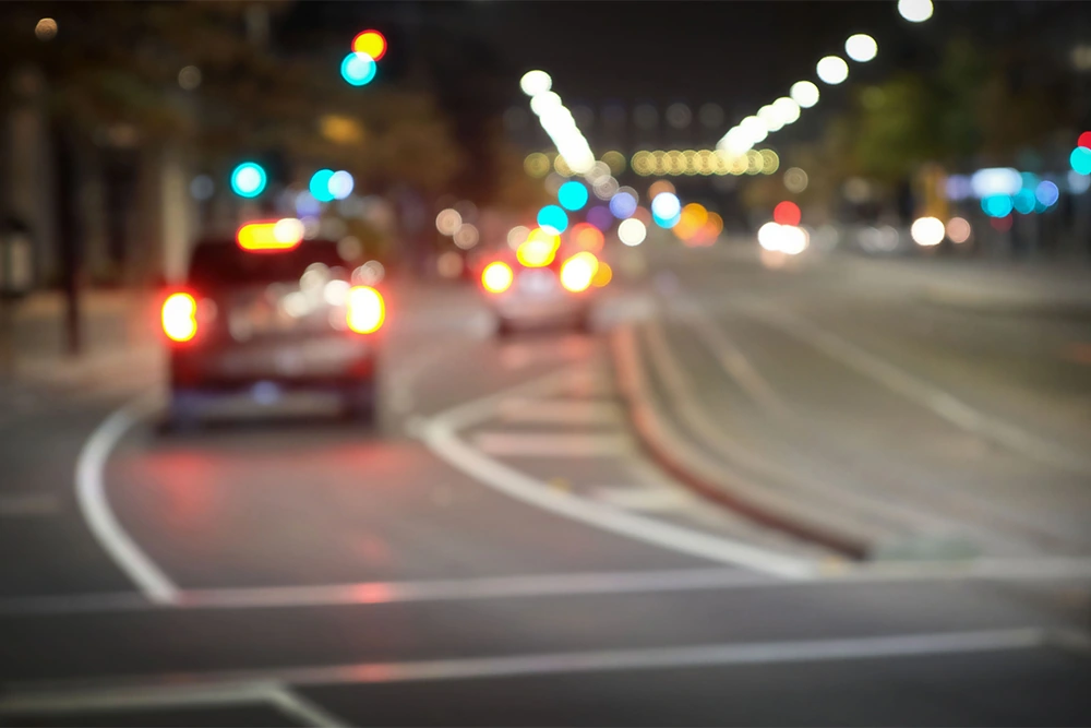 blurry lights while driving at night point of view